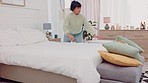 Bedroom, bed and woman change sheets, cleaning her room and packing pillows on morning routine. Laundry, comfort and housework by black girl start her day with fresh bedding, happy clean living space