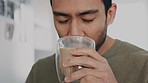 Wellness, relax and coffee with a man drinking, smile and happy with his choice of breakfast in a kitchen. Asian guy enjoying the comfort of refreshing drink, stress relief and cozy in his home alone