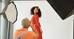 Creative photographer, black woman fashion model and photography studio shooting on white background for clothing brand. Teamwork, professional and black people pose on backdrop for clothing company
