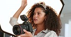Photographer, fashion and model with a woman photography professional taking a photograph in studio with a camera. Behind the scenes, backstage and catalog with a young female at work in modeling 
