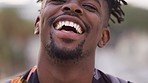 Black man, portrait and laughing face outdoor in Jamaica happy about funny joke, comic and freedom. Young, crazy and smile guy of comedy, humor and cool attitude in urban city to relax with happiness