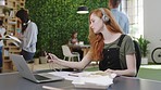 Phone, music and notebook with a creative woman designer working at a desk with her laptop and writing. 5g, internet and idea with a female employee listening to audio on headphones for motivation
