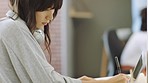 Asian woman writing, laptop and creative research design at  web developing software and coding company. China girl, cybersecurity and website code developer write in notebook  at digital tech agency