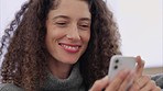 Woman on cellphone using social media, watch funny videos and texting on sofa at home. Smile, female and smartphone user happy on couch on internet, laugh and relax streaming online, movie and chat.