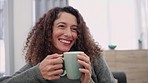 Relax, smile and woman drinking coffee on a sofa while sitting in the living room at home. Happy, laugh and lady from colombia relaxing and enjoying a cup of tea on the couch in her modern house.