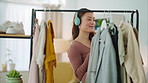 Woman, closet and fashion listening to music dance while looking at clothes in home bedroom. Girl, happy and outfit dancing in shop, store or boutique for shopping, streaming and song on headphones