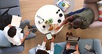 Marketing and advertising team planning, conversation and strategy in an office from above with tablet and laptop. Teamwork, paperwork and people in collaboration on a company market research plan