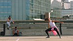 Street dancing, performance team and woman with group dancing in the road, energy with rave music and friends in collaboration for dance in the city. Professional dancer with teamwork for competition