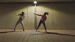 Night dancing, street performance and women with energy from music doing dance to disco audio on radio and on the dark road for commitment to competition in city. Dancer team doing hip hop in town