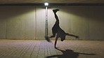 Dance, flexible and hip hop dancer to music while training for performance outdoor. Freedom, art and creative young man dancing moving to the rhythm or beat of a song with a gray background at night