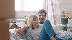 New house, boxes and couple relax on sofa together happy for real estate property. Moving, success and new start with happy, excited people on couch furniture in lounge or living room home apartment