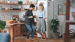 Dance, freedom and love with couple in kitchen in celebration, energy or wellness together. Happy, relax and health with man and woman dancing and listening to music at home for joy, fun or lifestyle
