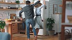 Love, happy and couple dance in kitchen with freedom, bonding and enjoy fun quality time together while relax at home. Spin, marriage and happiness for romantic man and woman dancing with high energy