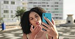 Black woman, phone and social media love in city with smile for connectivity and communication. Happy African American female in social conversation wave, kiss or sign on smartphone in South Africa