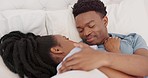 Bed, love and happy black couple romance kiss relax together on honeymoon or holiday vacation. Married African American man, woman smile and morning routine happiness relationship bonding in bedroom