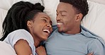 Love, smile and happy couple in bed, relax and laugh together in the morning with conversation, communication and talk. Black man and woman in healthy marriage relationship talking with in bedroom