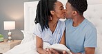 Love, kiss and couple in bedroom with tablet ecommerce gift surprise for marriage anniversary. Excited smile of married black couple in bed with happy wife reading online present notification.

