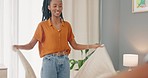 Blanket, morning and couple making the bed together in their house. Young, happy and African man and woman with smile for teamwork, collaboration and partnership in marriage while cleaning bedroom