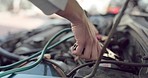 Breakdown, jumper cables and engine with the hands of a woman having car trouble while on a road trip. Travel, electricity and battery with a female trying to power her vehicle while out for a drive