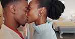 Happy black couple, kiss and dance for love, care and embracing relationship together at home. African American man and woman relaxing while sharing a dance, kissing and hugging for anniversary date