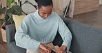 Black woman, unpacking and delivery box with clothes parcel in house living room with happy customer opening online shopping, ecommerce or internet order. Smile of female with fashion package at home