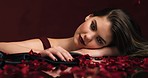 Model, makeup and flowers in beauty, zoom of rose and face for cosmetics or skincare. Girl, red and plant blossom in advertising, marketing or portrait for brand or cosmetic company in closeup
