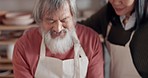 Pottery, creative and senior couple talking about art with hug and kiss together in a studio class. Elderly Asian man and woman hugging with love while learning and working with clay on a date