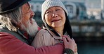 Love, hugging and senior asian couple in the city, enjoying travel vacation in Amsterdam. Elderly Chinese man and woman talking, embracing and holding each other, smile on face and happy together