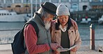 Love, travel and old couple reading a map and pointing to a direction on their adventure journey on holiday vacation. Tourism, lifestyle and Asian woman searching for a location together in Cape Town