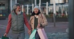 Senior couple, shopping and holding hands, together and bonding outdoors in city. Retirement, talking about discount and sale, Asian and elderly people, shopping bag and spending quality time