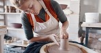 Pottery wheel, woman and sculpture in artist studio, workshop and small business of creative product, craft and manufacturing. Ceramic designer, clay artisan and expert mold form for handmade process