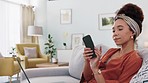 Woman, laptop and phone call on sofa for remote work, customer support or crm job. Girl, happy and working with computer in home customer service, help and consulting in living room at her house