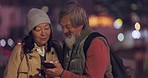 People reading social media meme, senior asian couple in city at night and 5g wifi network in Seoul. Happy elderly tourist on smartphone, woman talking on video call and online communication together