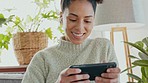 Smartphone, gaming and gamer black woman excited for action, esports or online mobile app use experience on her living room sofa. Winning, happy woman play fast internet video game on her cellphone