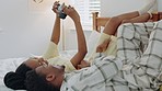 Camera, comic and African couple with photo in a bed for love, relax and happiness in their house. Happy, smile and funny black man and woman with picture with a vintage camera in the bedroom