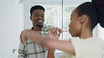 Couple, brushing teeth and dance in a bathroom while cleaning, brushing and oral hygiene, fun and morning grooming. Dental, music and woman dancing with man while getting ready together at home