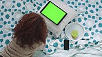 Relax, green screen and tablet with woman in bed for streaming for internet, social media or movie online. Technology, website and digital with girl at home for app, music or mockup chroma key