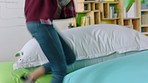 Relax, pillow and student woman jumping on colorful bed or bean bag, sleeping and resting on break. Startup, business or company office female from Canada in trendy, gen z or modern workplace resting