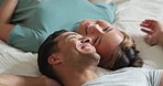 Happy people in bedroom, couple talking of love and marriage bonding happiness in Mexico home. Indian man joke with girlfriend on bed, relax in hotel together and young asian woman laughing smile