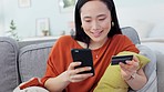 Credit card, ecommerce and asian woman on sofa, phone payment and fintech for online shopping in living room house. Customer, smartphone banking and mobile app money, internet finance and technology 