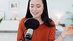 Microphone, home studio and woman recording a podcast for the radio or social media platform. Happy, creative and Japanese influencer talking with mic on a live streaming network for online audience.