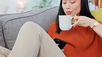 Asian woman, phone or drinking coffee on relax sofa in house lockdown or home living room. Smile, happy or tea for student on mobile technology for social media app, live streaming movies or internet