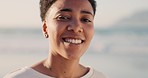 Happy black transgender person at beach, natural portrait on outdoor vacation and bright smile of teeth. Sunset at sea with young non binary lesbian and androgynous freedom in travel lifestyle