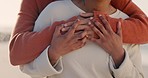 Love, hands and lesbian couple hug at ocean on a romantic holiday, care and freedom on weekend break. Romance, support and lgbt pride in embrace, arms holding or hugging together on beach in summer.