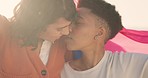 Love, lesbian and kiss with couple for freedom with flag at beach for lgbtq, gay pride and happy together. Peace, acceptance and lifestyle with young women for partner, relationship and celebration