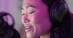 Asian woman, podcast and headphones, microphone and influencer, podcaster or host talking. Presenter, speaker and happy female from Japan on mic for talk show, radio broadcast or live streaming audio