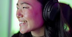 Asian, woman and gamer with headphones with smile in room for game, competition or contest on internet. Girl, happy or online gaming in home for esports, excited and tech in closeup for video game