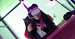 Gamer girl, virtual reality and metaverse esports gaming online in room with digital video game on gaming chair. High tech ps5 console, neon light and vr headset for futuristic cyber game competition