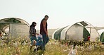 Mother, father and child holding hands on a chicken farm as a happy family walking on a field harvesting poultry livestock in Medellin. Farmers, farming and parents enjoy quality time with young girl