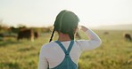 Farmer, child and pasture for cow, herd or cattle in summer, sunshine and outdoor. Young, girl and farming with cows, bull and animal eating grass for agriculture, milk or meat on field in Argentina